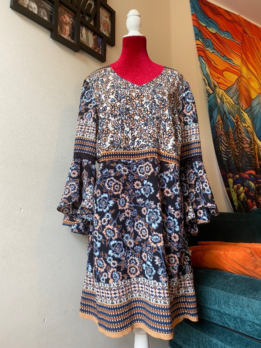 Westport 1962 dress featuring a black floral pattern and long flare sleeves.